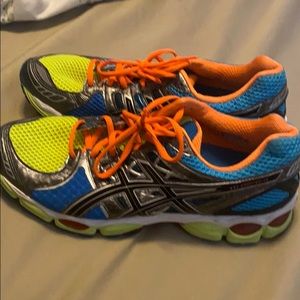 Gently used men’s ASIC tennis shoes. Multi color